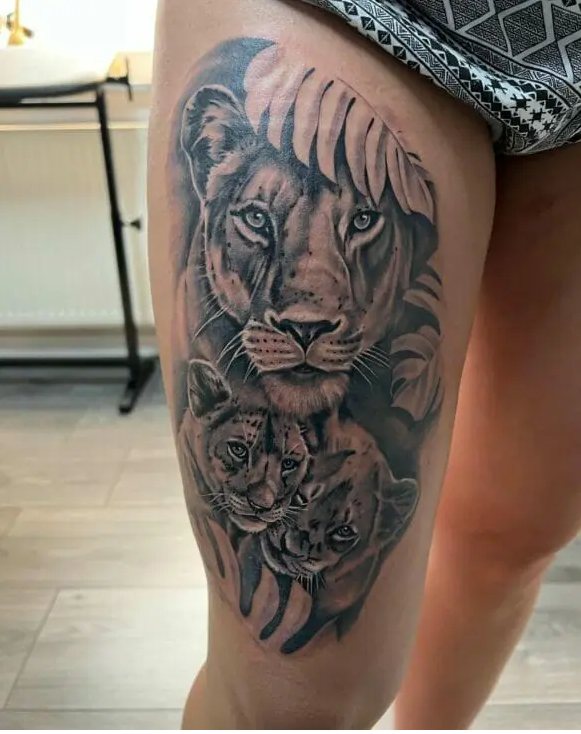 queen lioness and cub tattoo on thigh